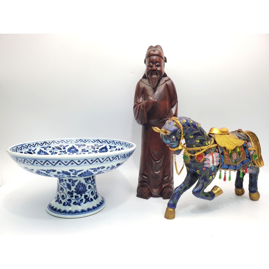 Lot of 3 Chinese Items: Lot of 3 Chinese Items Including Cloisonne Horse, Carved Wood Buddha Figure & a Blue & White Porcelain Footed Dish. Condition: Generally Good. As Found. Dimensions: Various Sizes. Figure-H-14.5".