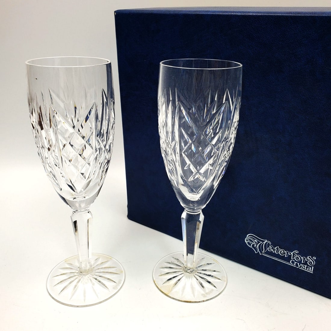 2 Waterford Crystal Champagne Glasses: 2 Waterford Crystal Champagne Glasses in Original Fitted Box. Condition: Excellent. Unused. Dimensions: Each Glass-H-7.4". Box-8.75" x 8.75" x 4.5". Provenance: From a New York City Apartment. Please 