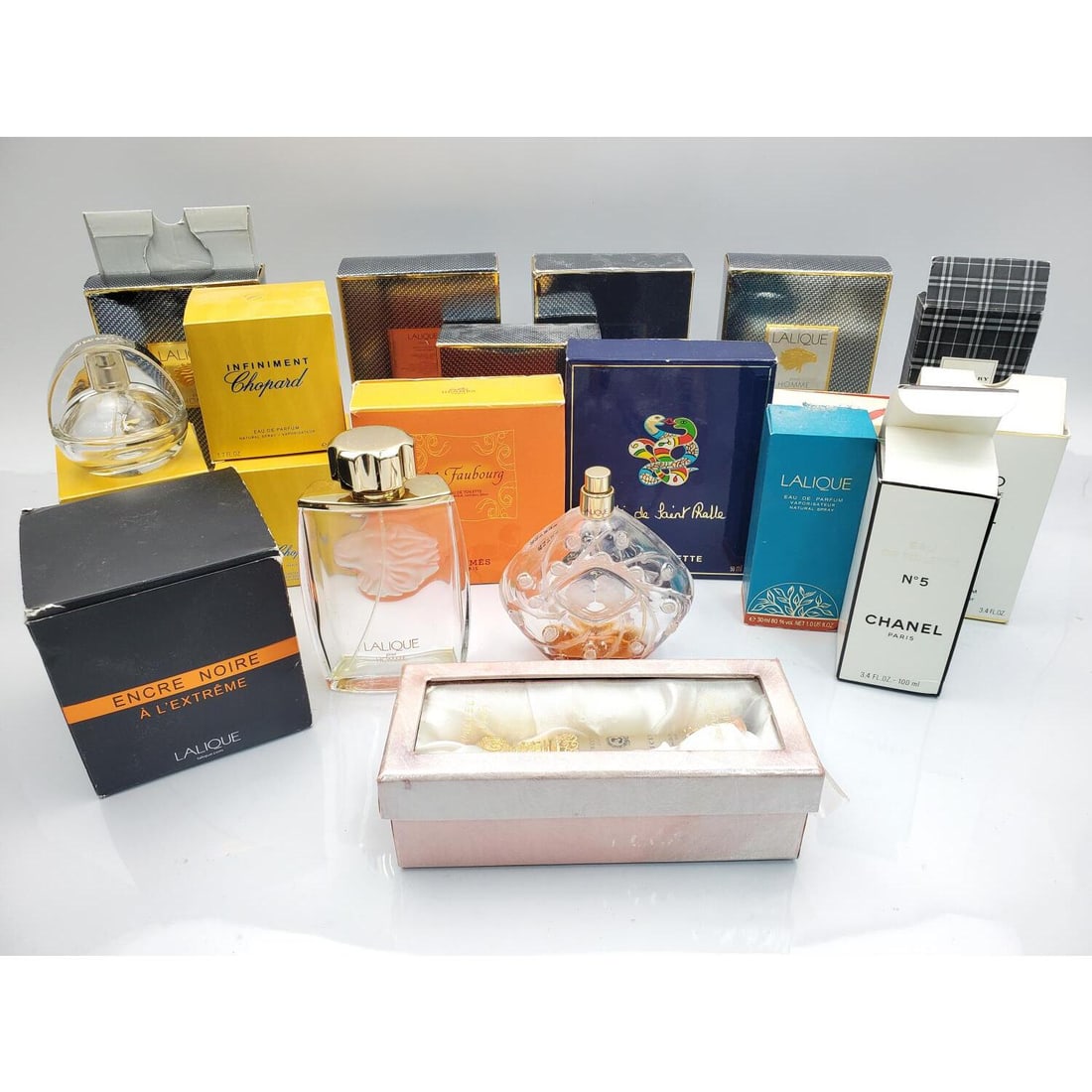 Large Lot of Used Designer Perfume Bottles: Large Lot of Used Designer Perfume Bottles by Lalique, Niki De Saint Phalle, Chanel, Hermes, Chopard & Others. Condition: Used. Sold As Is. Dimensions: Various Sizes. Provenance: From a Long Island, N