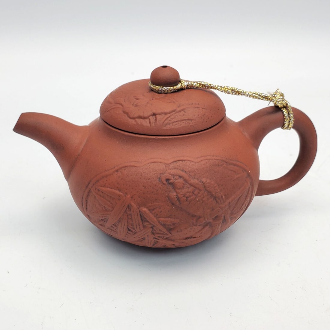 Chinese Small Pottery Tea Kettle w/ Seal: Chinese Small Pottery Tea Kettle w/ Seal on Underside Depicting Birds. Condition: Generally Very Good. Dimensions: L-5". Provenance: From a Long Island, NY Home. Please note the absence of a Condition
