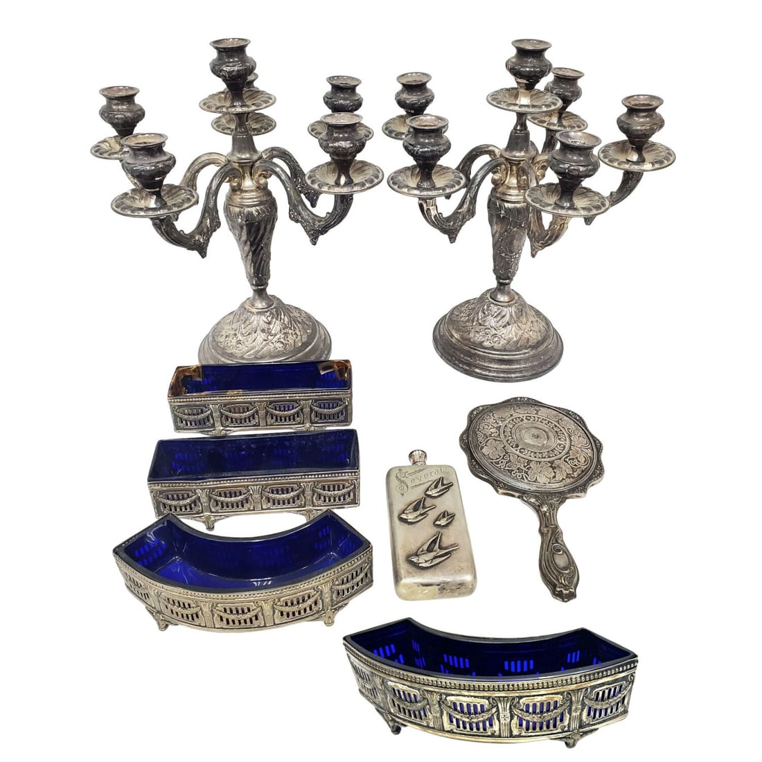 Lot of 8 Antique Silver Plated Items: Lot of 8 Antique Silver Plated Items Including a Pair of 6-Light Candelabras, 4 Vases w/ Cobalt Blue Inserts, & a Hand Mirror. Condition: Heavily Tarnished & 1 Cobalt Blue Insert is Broken. Dimensions