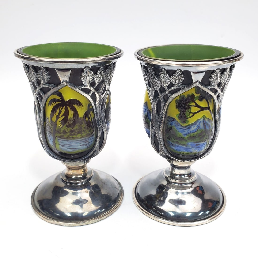 Lot of 2 Cameo Glass & Metal Cups: Lot of 2 Cameo Glass & Metal Cups. Condition: Generally Very Good. Dimensions: Both H-4.75" x Dia-3" Provenance: From a Long Island, NY Home.Please note the absence of a Condition Report does not impl