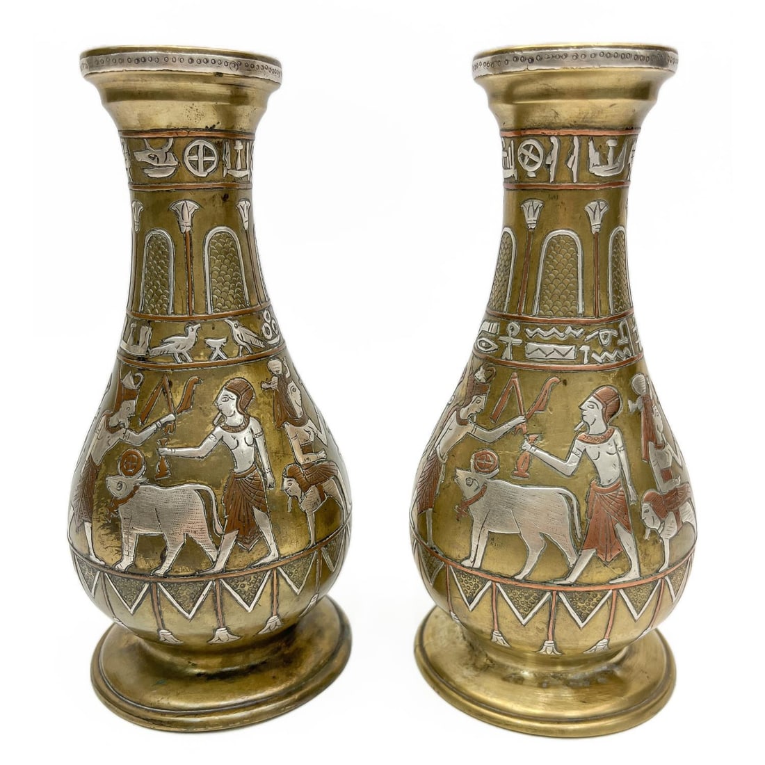 Antique Pair of Egyptian Heavy Brass Vases: Antique Pair of Egyptian Heavy Brass Vases w/ Inlayed Silver & Copper Depicting Hieroglyphic Scenes. Cira 1920's. Condition: Generally Very Good. Dimensions: H- 8". Provenance: From a Long Island, NY 