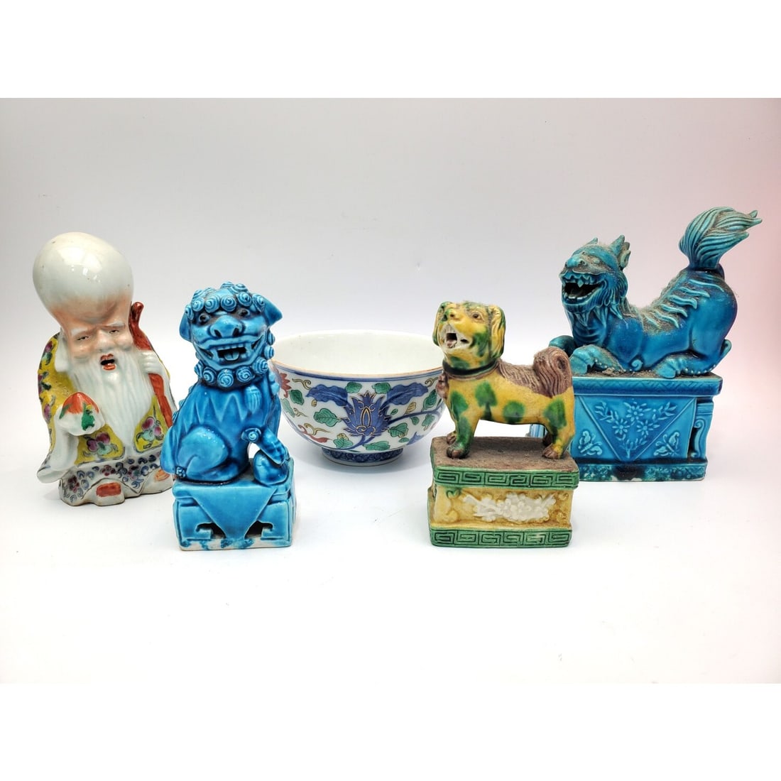 Lot of 4 Chinese Porcelain Items: Lot of 5 Chinese Porcelain Items Including 3 Foo Dog Figures, a Signed Bowl & a Figure of a Wise Man. Condition: Generally Good. Dimensions: Largest-H-5.5" x L-4".Provenance: From a Long Island, NY