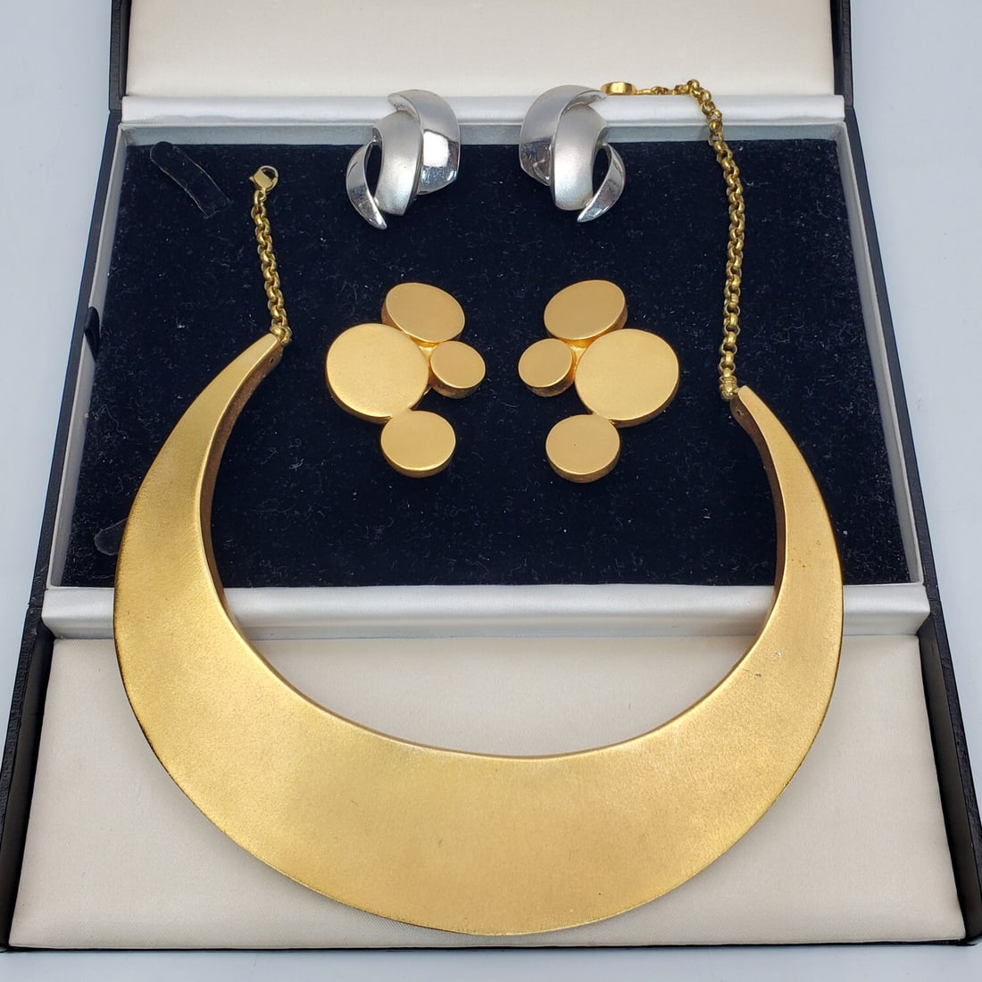 Lee Wolfe 3 Piece Set of Modernist Jewelry: Lee Wolfe 5 Piece Set of Modernist Jewelry Including a Large Necklace & 2 Pairs of Earrings. All Fully Marked. In a Nice Box. Condition: Generally Very Good. Dimensions: Necklace-Dia-6.5". Box-8.25" x