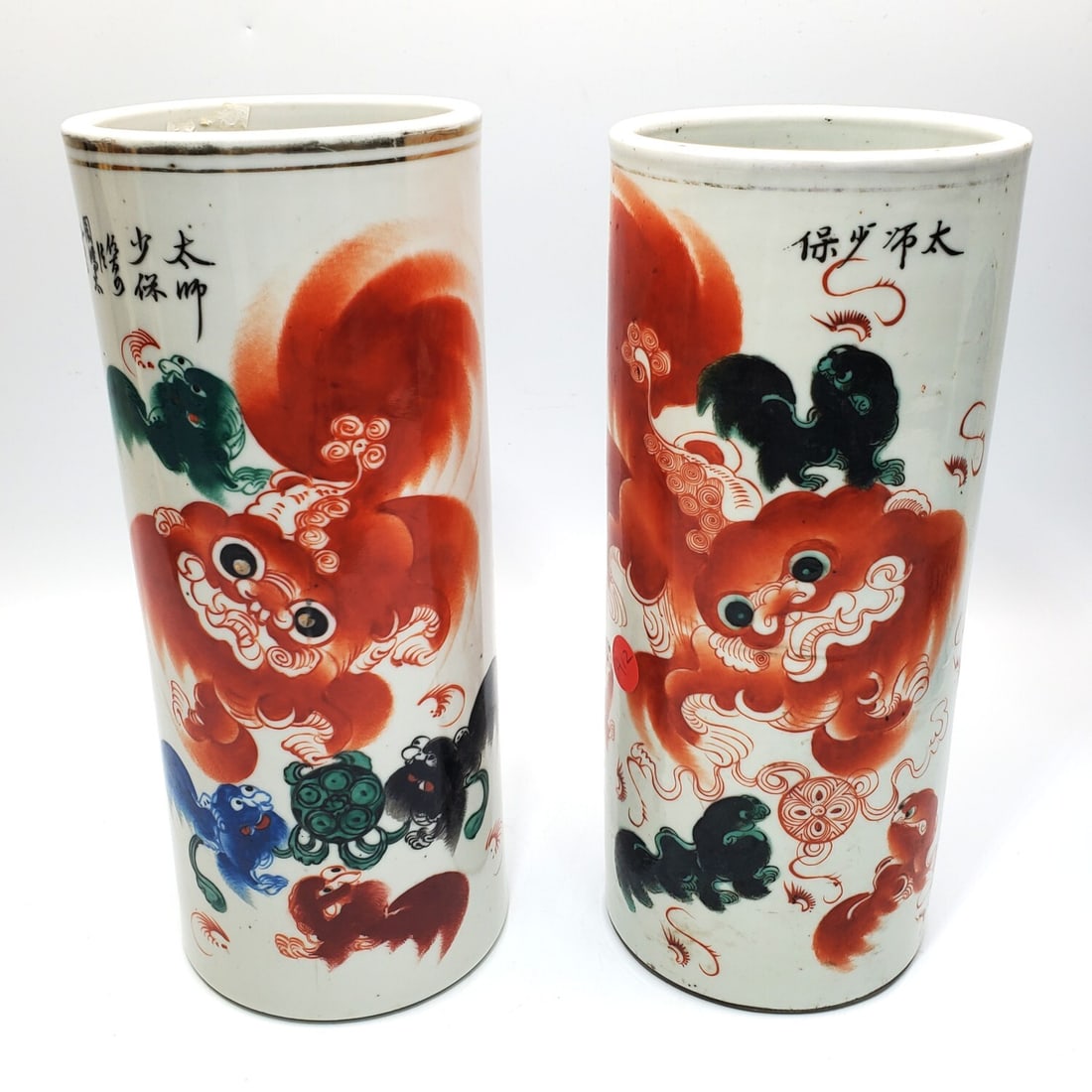 Chinese Lot of 2 Porcelain Vases: Chinese Lot of 2 Porcelain Vases w/ Foo Dogs & Chinese Writing. Condition: Generally Good.Dimensions: H-11.25" x Dia-4.75". Provenance: From a Long Island, NY Home. Please note the absence of a Condit
