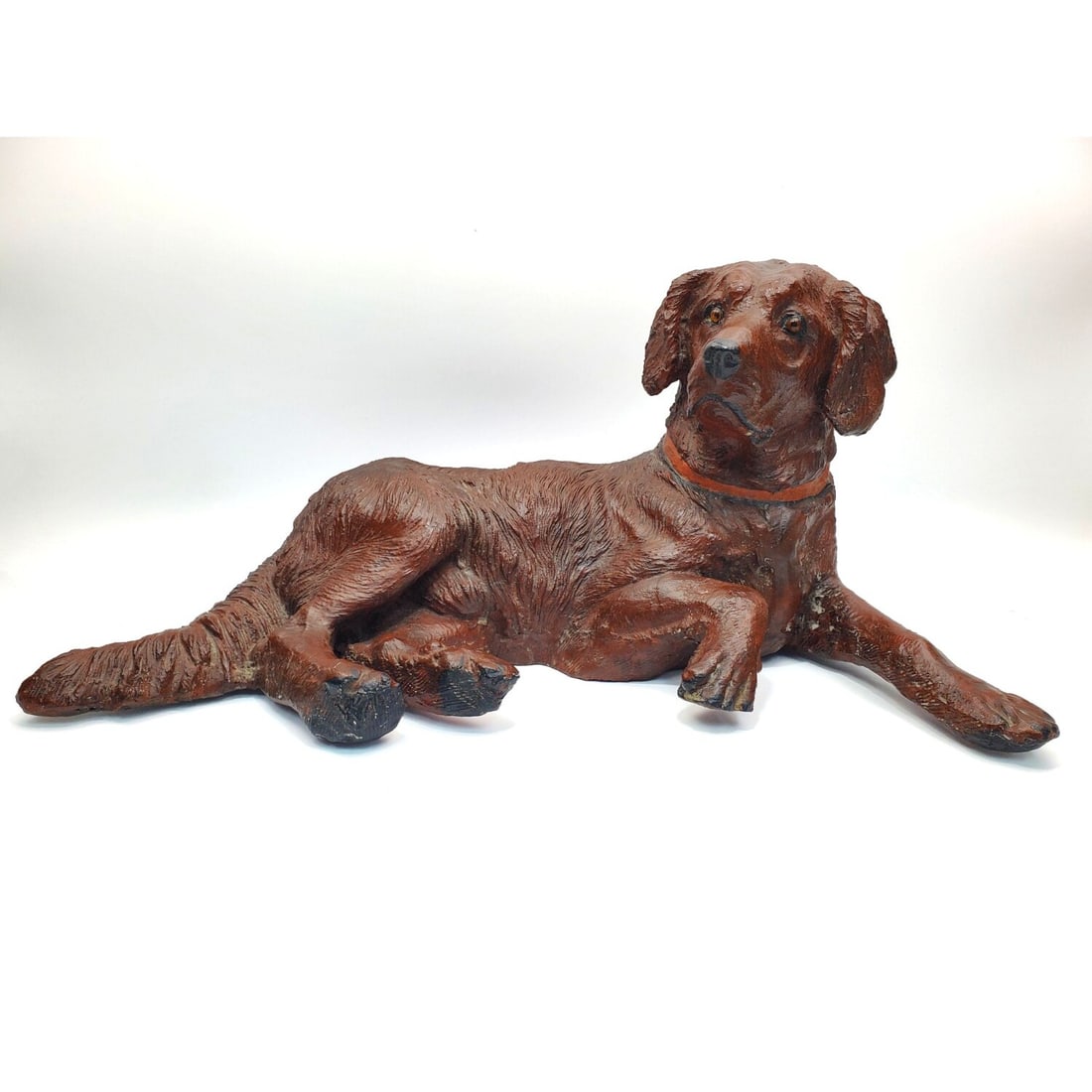 Old Resin Figure of a Chocolate Labrador Dog: Old Resin Figure of a Chocolate Labrador Dog Laying Down w/ Glass Eyes. Condition: Generally Good. Dimensions: L-23" x W-10" x H-11". Provenance: From a Long Island, NY Home.Please note the absence of