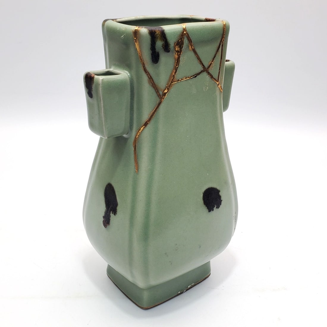 Chinese Green Glazed 2-Handle Vase: Chinese Green Glazed 2-Handle Vase w/ Gold Color Restoration. Condition: Generally Good.Dimensions: H-8.75" x W-4.75". Provenance: From a Long Island, NY Home. Please note the absence of a Condition R