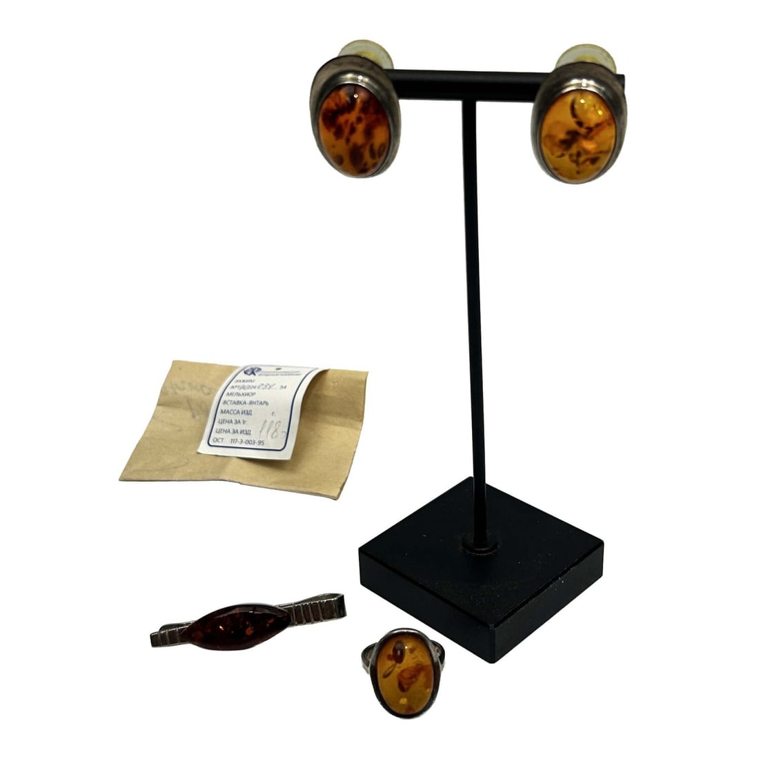 4 Amber Jewelry Items Including Silver Mounted: Lot of 4 Amber Jewelry Items Including a Pair of Silver Mounted Earrings, a Silver Mounted Ring & a Russian Tie Clip. Condition: Generally Good. Dimensions: Ring Size 6.25. Clip-L-2". Provenance: From