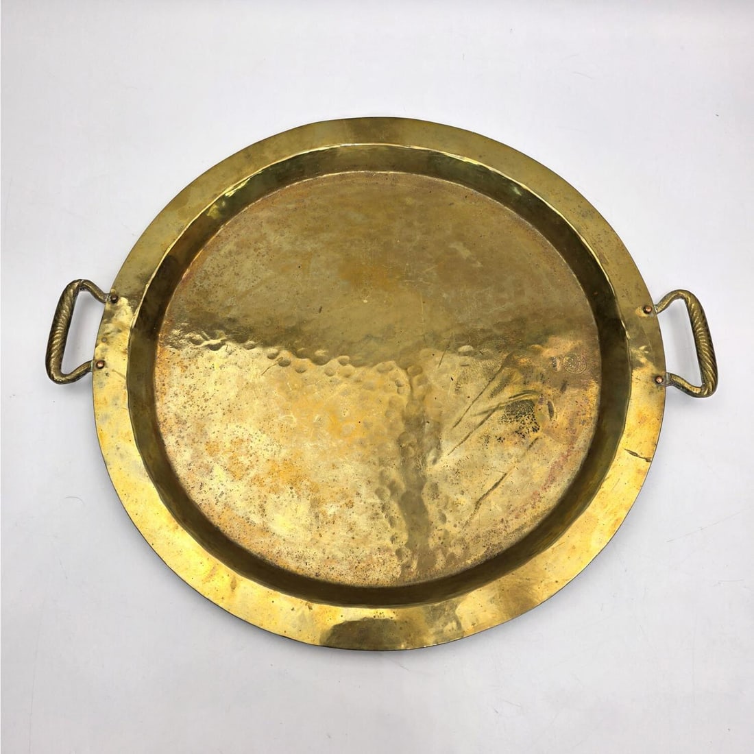 Antique Hand Hammered Brass Tray: Antique Hand Hammered Brass Tray. Probably Russian or Polish. Marked. Condition: Generally Good. Dimensions: Dia-13.75". Handle to Handle-16". Provenance: From a New York City Apartment. Please note t