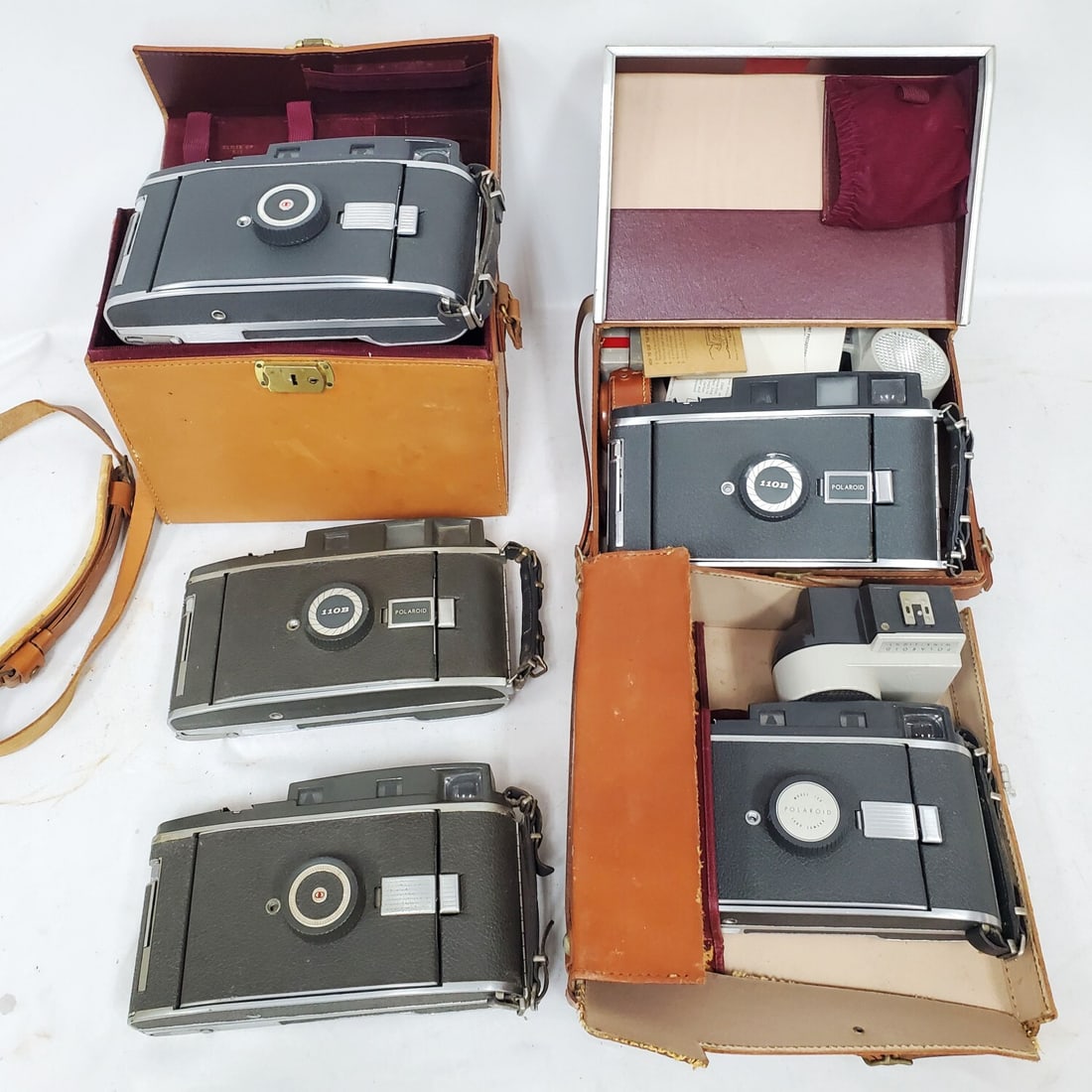 Lot of 5 Vintage Polaroid Land Cameras: Lot of 5 Vintage Polaroid Land Cameras Including Pathfinder Model 110B & 150. Some in Original Fitted Cases w/ Equipment & Accessories. Condition: As Found. Please Note- We Do Not Guarantee The Workab