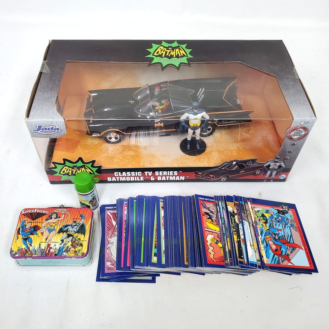 Batmobile Die-Cast Metal Model & Others: Batmobile Die-Cast Metal Model From The 1966 Classic TV Series Along With Justice League Trading Cards & A Hallmark Keepsake Super Friends Lunch Box Ornament. Condition: Generally Good. Sold As Is. Di