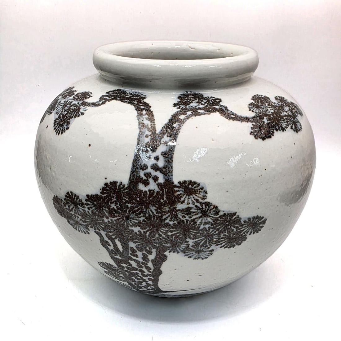 Korean Porcelain Moon Jar: Korean Porcelain Moon Jar w/ Pine Tree Decoration. Condition: Generally Good. Dimensions: H-9" x Dia-10". Provenance: From a Long Island, NY Home. Please note the absence of a Condition Report does no