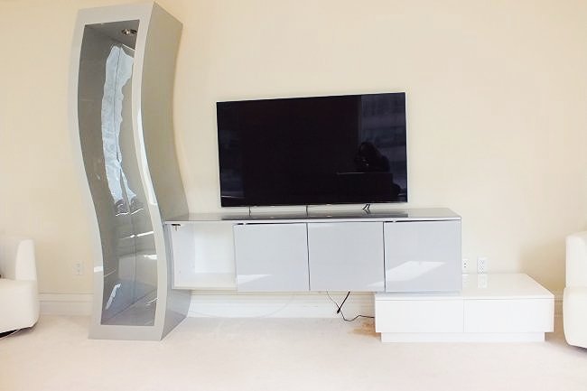 Modernist Wall Unit by Roche Bobois: Lovely modern wall unit with mirrored wavy shelf Note: one cabinet door is missing, two cabinet doors are loose Cabinet Section is 74" long, 18 2/8" wide and 31 1/2" high Drawer Section is 42" long, 2