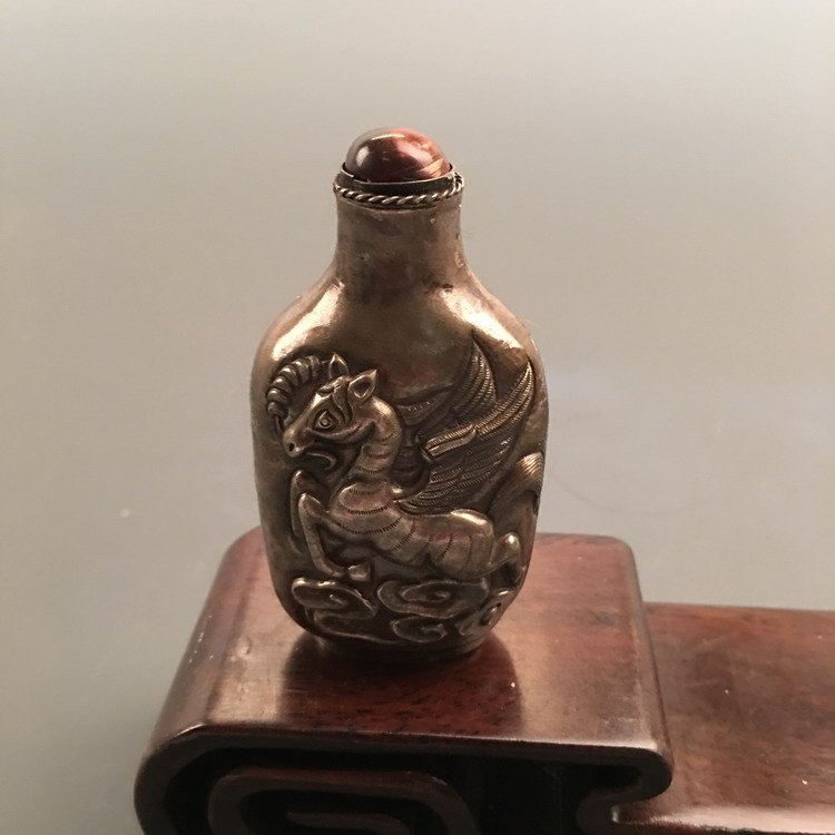An Old Silver Snuff Bottle: An Old Silver Snuff Bottle 3" H x 1-3/4" W, 1.38 Oz Shipping: We are able to pack and ship this item to an address in the United States for $20.00 via UPS Ground or USPS Priority Mail. Tracking inform