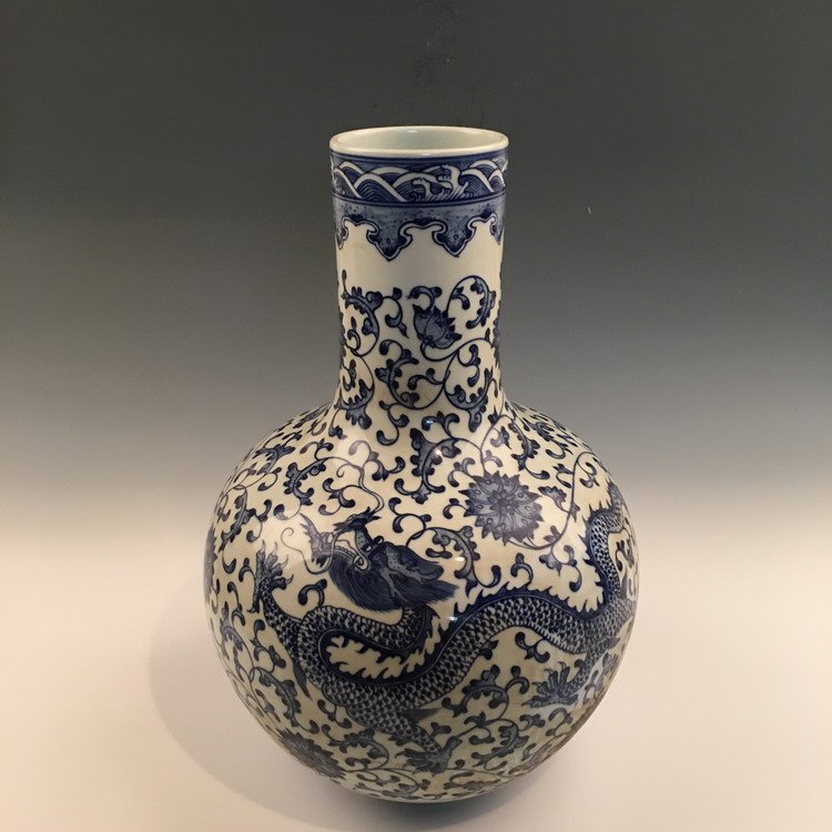 Chinese Blue and White Dragon Vase: Chinese Blue and White Dragon Vase with Qianlong Mark 12-1/4" H X 11-1/2" Diam., 11.2 Oz Shipping: We are able to pack and ship this item to an address in the United States for $45.00 via UPS Ground o