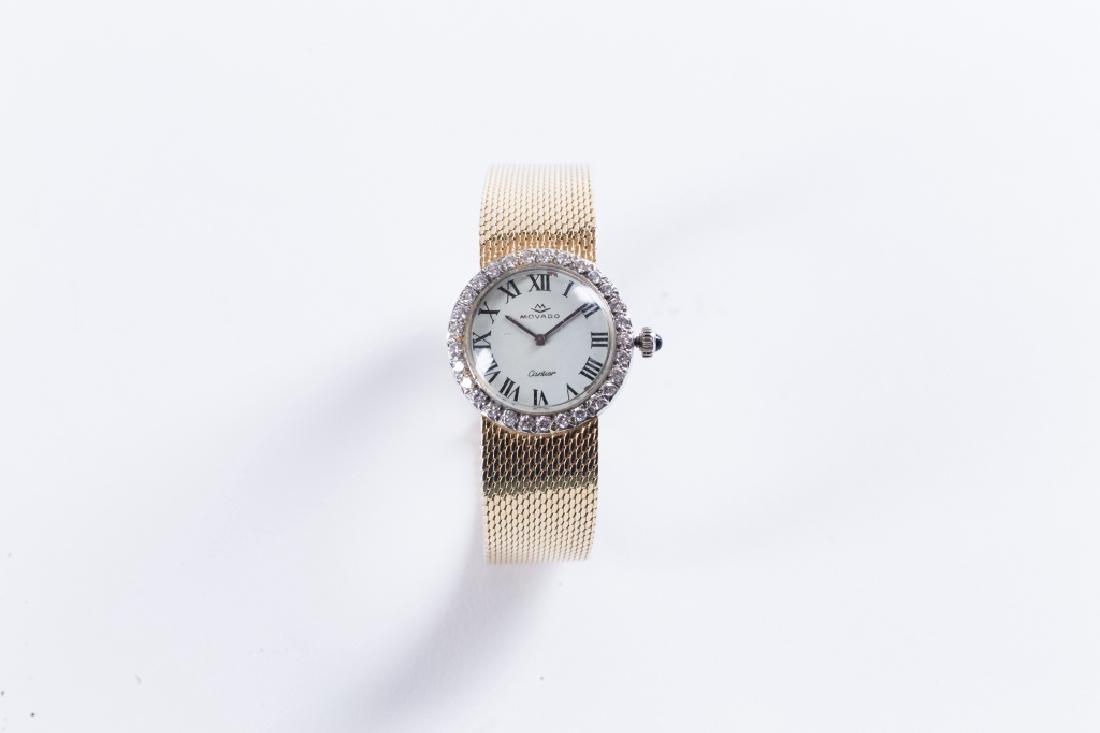 A CARTIER LADY'S DIAMOND WATCH: Lady's Cartier 14K yellow gold diamond watch with sapphire winder circa 1960's. Bezel set with 30 round brilliant cut diamond _x0008_weight approx 0.60 ct GH VS fine cut. Watch length measures 6.2 in.
