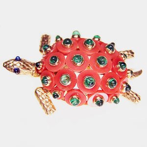 Cartier Coral Turtle Clip: Cartier Coral Turtle Clip A Cartier brooch in the form of a turtle with carved coral discs set with emerald cabochons as the shell. 18ct yellow gold. Paris. Circa 1950. For more or higher resolution p