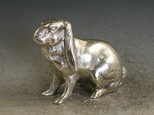 Victorian Novelty Silver English Lop Eared Rabbit: A very fine quality and rare cast novelty silver Pepper made in the form of an English Lop Eared Rabbit, sitting on its hind legs, with screw off cover to the base. By James Barclay Hennell, London, 1