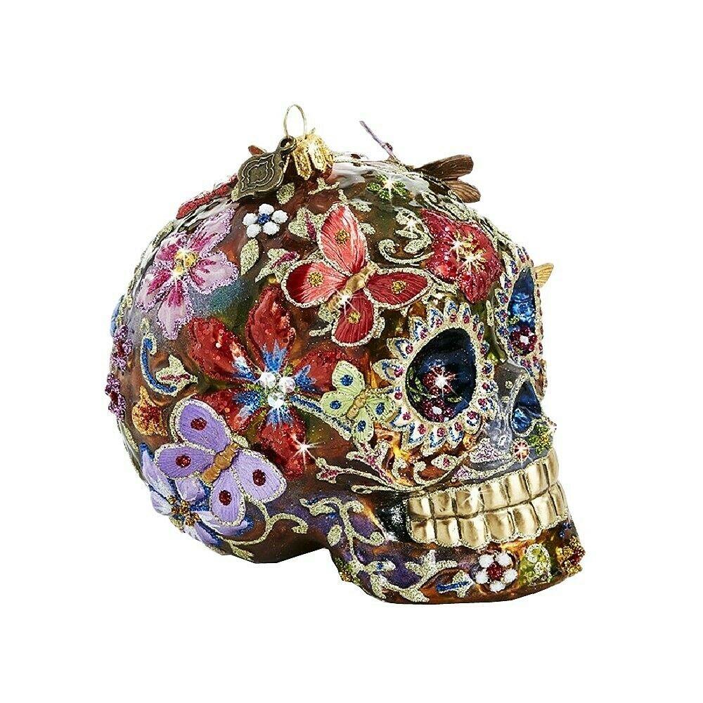 JAY STRONGWATER 4.5" Tall SKULL BUTTERFLIES ORNAMENT: JAY STRONGWATER4.5" FLORAL SKULL WITH BUTTERFLIES GLASS ORNAMENT4.5" Tall x 4.25" Wide x 2.5" DeepSkull With Butterflies Glass Ornament Was first sculpted in clay and then mouth-blown in glass By old-