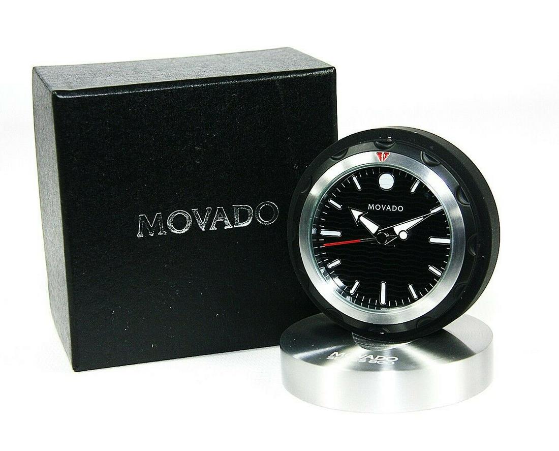 MOVADO MUSEUM DIAL SLEEK AND VERSATILE TRAVEL ALARM CLOCK: MOVADO"CAN" CLOCKTRAVEL ALARM CLOCKBRAND NEW IN ORIGINAL MOVADO BLACK BOXWith ORIGINAL Foam InsertsMODEL: RBL000218M2 1/2" DIAMETER x 1" THICK (closed in the "can")3/4" THICK (opened)Battery in the pi