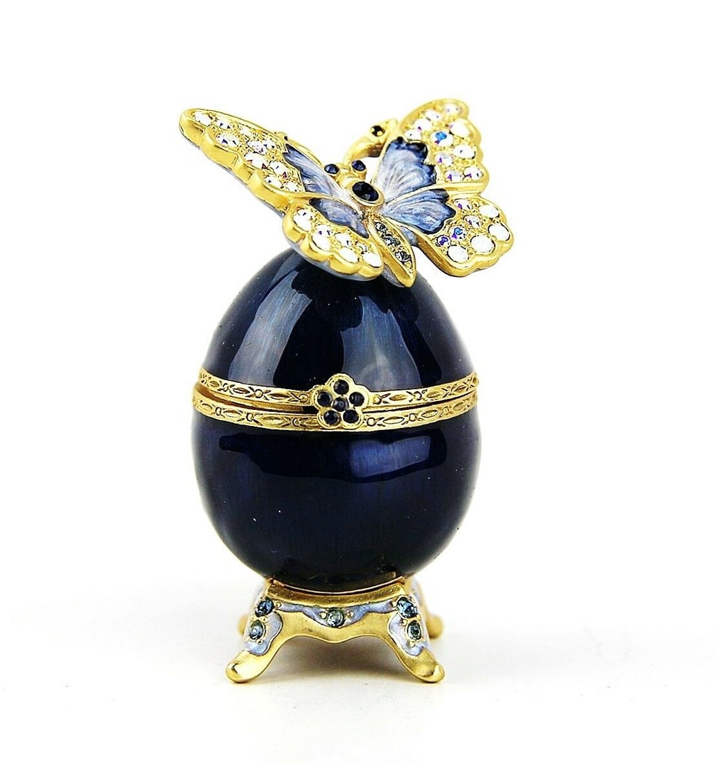 JAY STRONGWATER AMELIE BUTTERFLY EGG TRINKET BOX DELFT GARDEN with SWAROVSKI CRYSTALS: JAY STRONGWATER BUTTERFLY EGG TRINKET BOXFrom INDIGO CollectionName: AmelieHandpainted Enamel Over Golden MetalEgg: 1.25" Diameter x 2.5" TallButterfly: 1.5" WideHAND SET SWAROVSKI CRYSTALSHANDCRAFTED