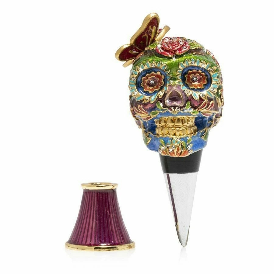 Jay Strongwater Calavera - Skull Wine Stopper and Stand14K: CalaveraInspired by the great heritage of Mexican Sugar skulls, we first carved our Calavera Skull wine stopper in clay with a raised all-over floral pattern highlighted with a jeweled fluttering butt