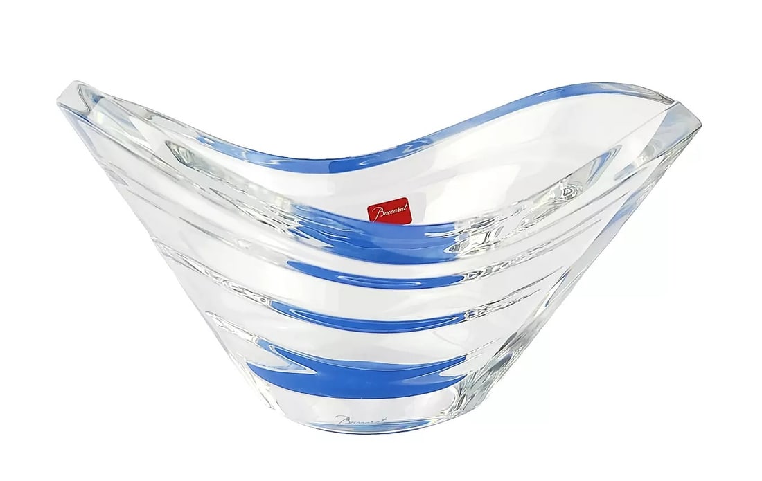 BACCARAT Wave Bowl Blue Brand New 2104986 Made in France: BACCARAT 2104986WAVE BOWL CLEAR CRYSTAL WITH BLUE ACCENTHANDCRAFTED FULL LEAD CRYSTALColor: CLEAR/BLUEMADE IN FRANCEENGRAVED Baccarat.8.5" Long x 5" Wide x 4.25" TallCrystal 0.5" Thick