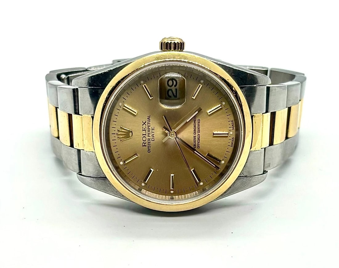 Rolex Date 34 mm Steel 18K Yellow Gold White Roman Watch 15203: Rolex Oyster Date 18k Gold Steel Watch 15203 #70METAL: 18k Gold/ Stainless Steel. MEASUREMENTS: Case 34mm, two tone oyster band will fit approx. 6.75" wrist. Gold tone dial with stick markers. MOVEMEN