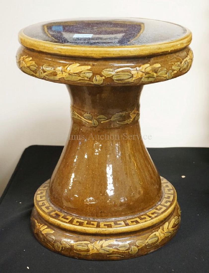 POTTERY GARDEN SEAT DECORATED WITH LEAVES. 16 INCHES: POTTERY GARDEN SEAT DECORATED WITH LEAVES. 16 INCHES HIGH. 13 INCHES WIDE.
