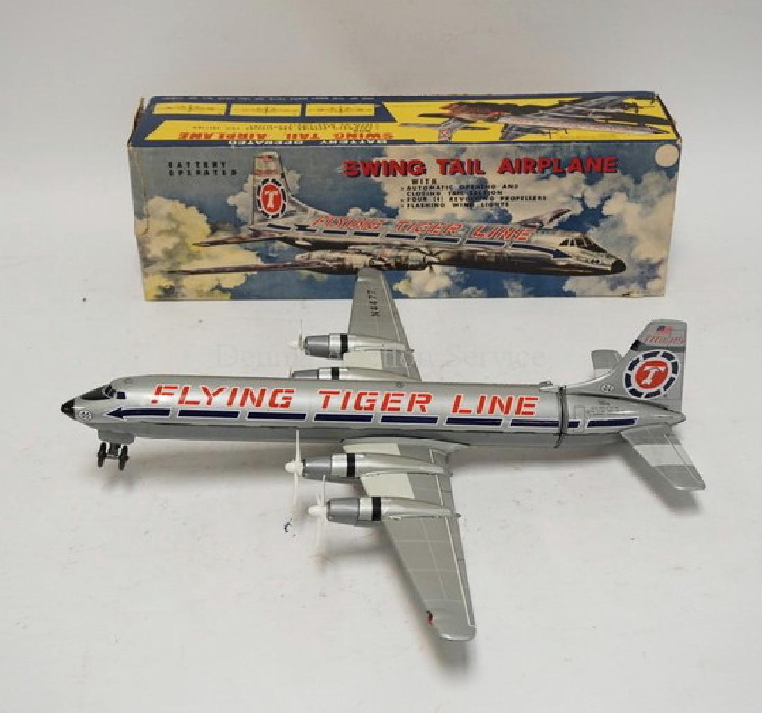 LOUIS MARX BATTERY OPERATED *FLYING TIGER LINE* SWING: LOUIS MARX BATTERY OPERATED *FLYING TIGER LINE* SWING TAIL AIRPLANE WITH BOX. 20 INCHES LONG.