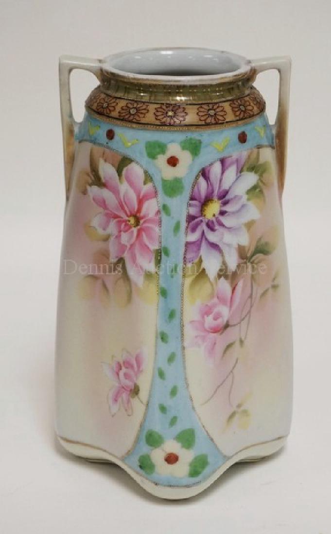 IMPERIAL NIPPON PORCELAIN VASE. HAND PAINTED WITH: IMPERIAL NIPPON PORCELAIN VASE. HAND PAINTED WITH FLOWERS. HAS A FACTORY BLEMISH ON ONE SIDE AND WEAR TO THE GOLD TRIM. 8 3/4 INCHES HIGH.