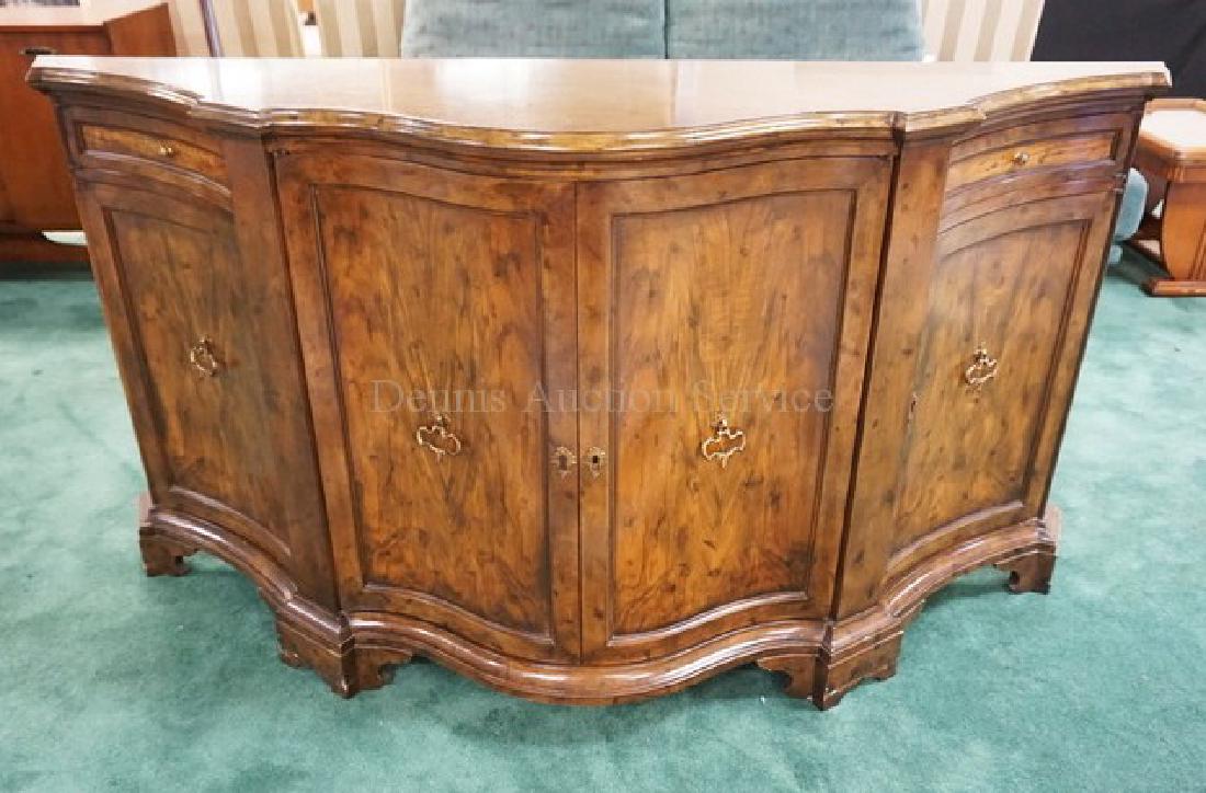 BAKER FURNITURE CREDENZA WITH A BOWED FRONT AND PANELED: BAKER FURNITURE CREDENZA WITH A BOWED FRONT AND PANELED DOORS. 67 INCHES WIDE. 35 1/4 INCHES HIGH.