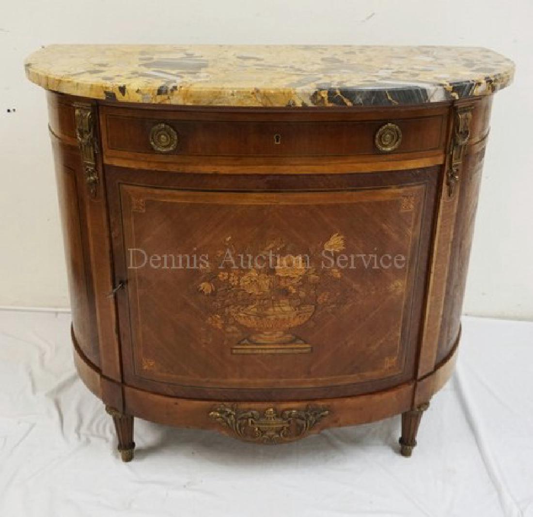 INLAID MARBLE TOP DEMILUNE CREDENZA WITH BRONZE MOUNTS.: INLAID MARBLE TOP DEMILUNE CREDENZA WITH BRONZE MOUNTS. FLORAL INLAY ON THE DOOR. 43 1/2 INCHES WIDE. 37 INCHES HIGH.