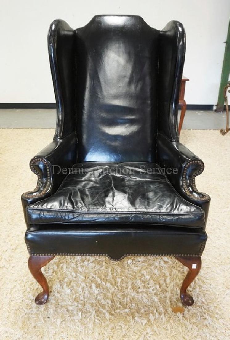 LEATHER WING CHAIR WITH A HIGH BACK AND CABRIOLE LEGS. (1 of 2)