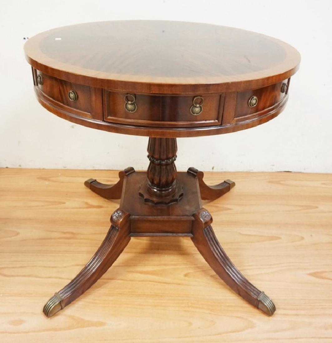 FLAME MAHOGANY DRUM TABLE WITH DUNCAN PHYFE LEGS AND A: FLAME MAHOGANY DRUM TABLE WITH DUNCAN PHYFE LEGS AND A FLUTED BALUSTER PEDESTAL. BANDED TOP. 4 DRAWERS. 33 INCH DIA. 32 INCHES HIGH.