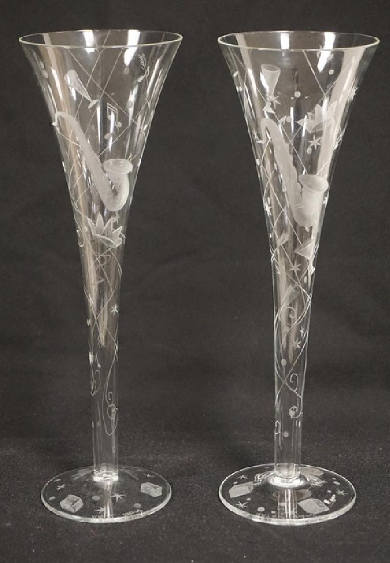 PAIR OF CUT CRYSTAL TOASTING FLUTES BY *ARTEL*. 10: PAIR OF CUT CRYSTAL TOASTING FLUTES BY *ARTEL*. 10 INCHES HIGH. CUTWORK INCLUDING A SAXOPHONE, DICE, ARROWS, ETC.