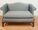 UPHOLSTERED SETTEE WITH CHIPPENDALE LEGS. 57 INCHES
