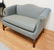 UPHOLSTERED SETTEE WITH CHIPPENDALE LEGS. 57 INCHES - 2