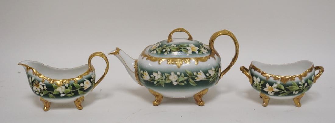 HAND PAINTED PORCELAIN TEAPOT, CREAM, & SUGAR. (1 of 2)
