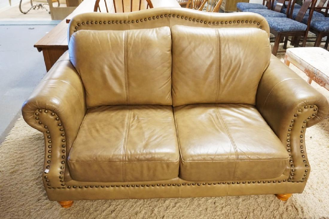 LIGHT BROWN LEATHER LOVESEAT MEASURING 62 INCHES WIDE. (1 of 1)