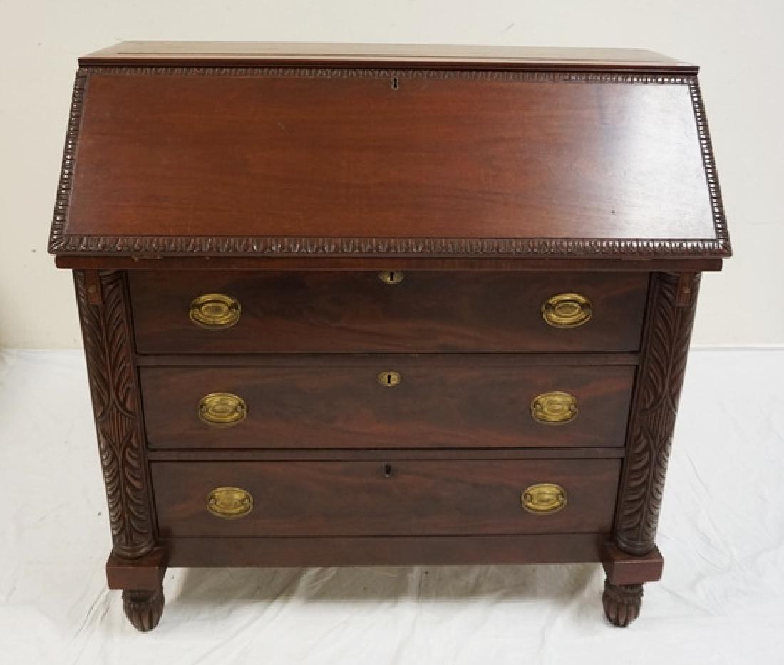 ANTIQUE MAHOGANY SLANT FRONT DESK WITH CARVED HALF: ANTIQUE MAHOGANY SLANT FRONT DESK WITH CARVED HALF COLUMNS, FIGURED DRAWER FRONTS, AND A RAISED PANEL TOP. 39 1/2 INCHES HIGH. 40 INCHES WIDE.