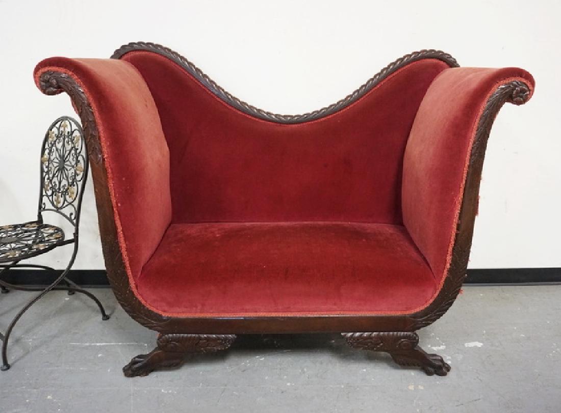 UNUSUAL HIGH BACKED LOVESEAT WITH A CARVED FRAME HAVING: UNUSUAL HIGH BACKED LOVESEAT WITH A CARVED FRAME HAVING PAW FEET. UPHOLSTERY HAS WEAR.