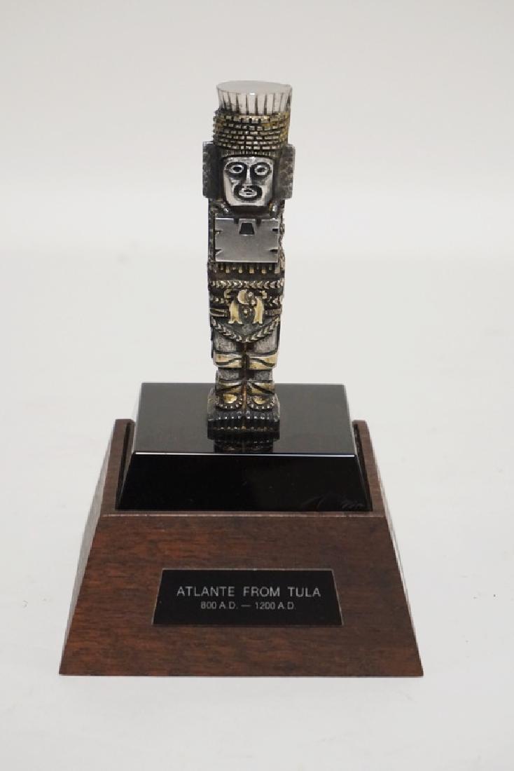 LUNT GALLERIES STERLING SILVER TOTEM. REPLICA OF A: LUNT GALLERIES STERLING SILVER TOTEM. REPLICA OF A STATUE IN HIDALGO, MEXICO. ISSUE #162. FLAKE ON THE BLACK BASE. HAS A WOODEN BASE W/PLAQUE. TOTAL HEIGHT 6 1/4 IN