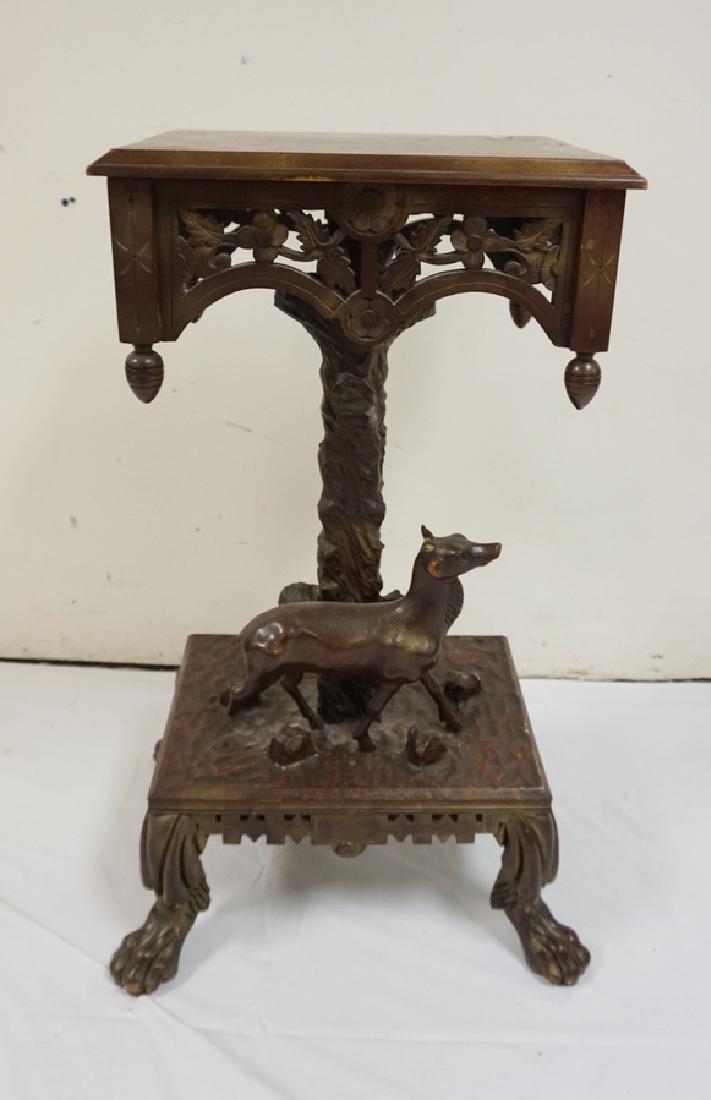 ORNATELY CARVED STAND FEATURING A DEER AND PAW FEET. (1 of 2)