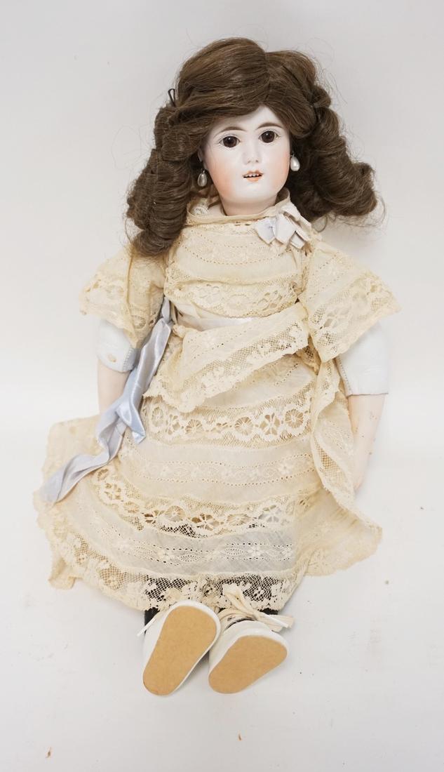 BISQUE HEAD DOLL WITH A LEATHER BODY. 16 INCHES LONG. (1 of 2)