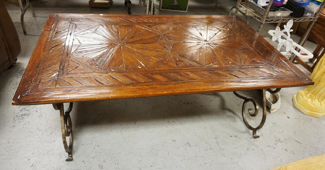 LARGE CARVED COFFEE TABLE WITH FANCY IRON BASE. 57 1/2 (1 of 4)