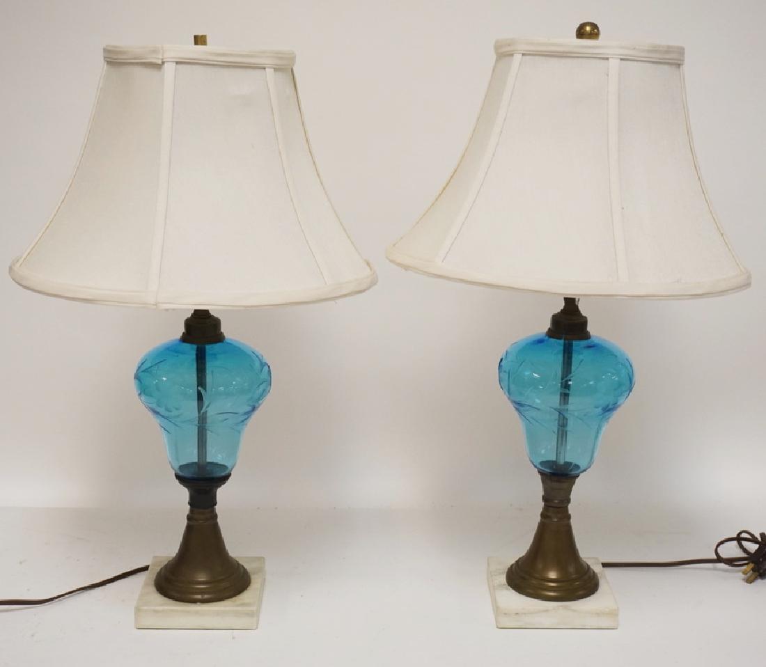 PAIR OF TABLE LAMPS WITH WHEEL CUT ICE BLUE BODIES: PAIR OF TABLE LAMPS WITH WHEEL CUT ICE BLUE BODIES ALONG WITH BRASS AND MARBLE MOUNTS. ONE BRASS COLLAR HAS A CRACK. 22 INCHES HIGH.