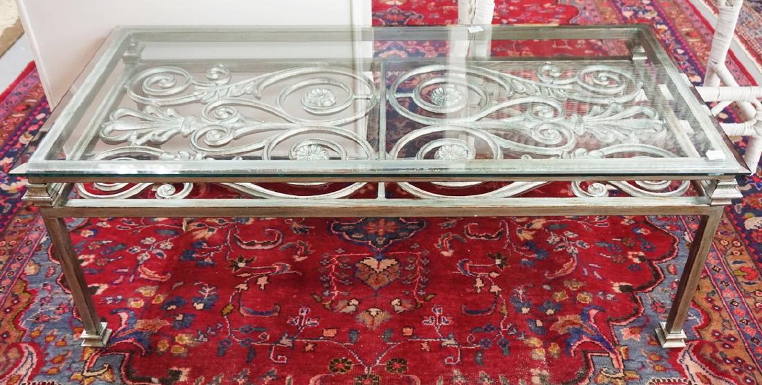 CAST METAL COFFEE TABLE WITH A GLASS TOP. 49 X 23 INCH: CAST METAL COFFEE TABLE WITH A GLASS TOP. 49 X 23 INCH TOP. 18 INCHES HIGH.