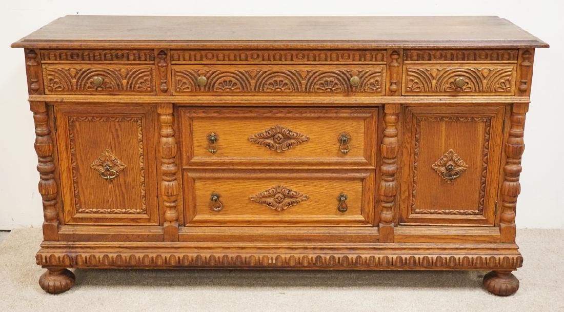 CARVED OAK SIDEBOARD MEASURING 65 INCHES LONG AND 35: CARVED OAK SIDEBOARD MEASURING 65 INCHES LONG AND 35 INCHES HIGH.